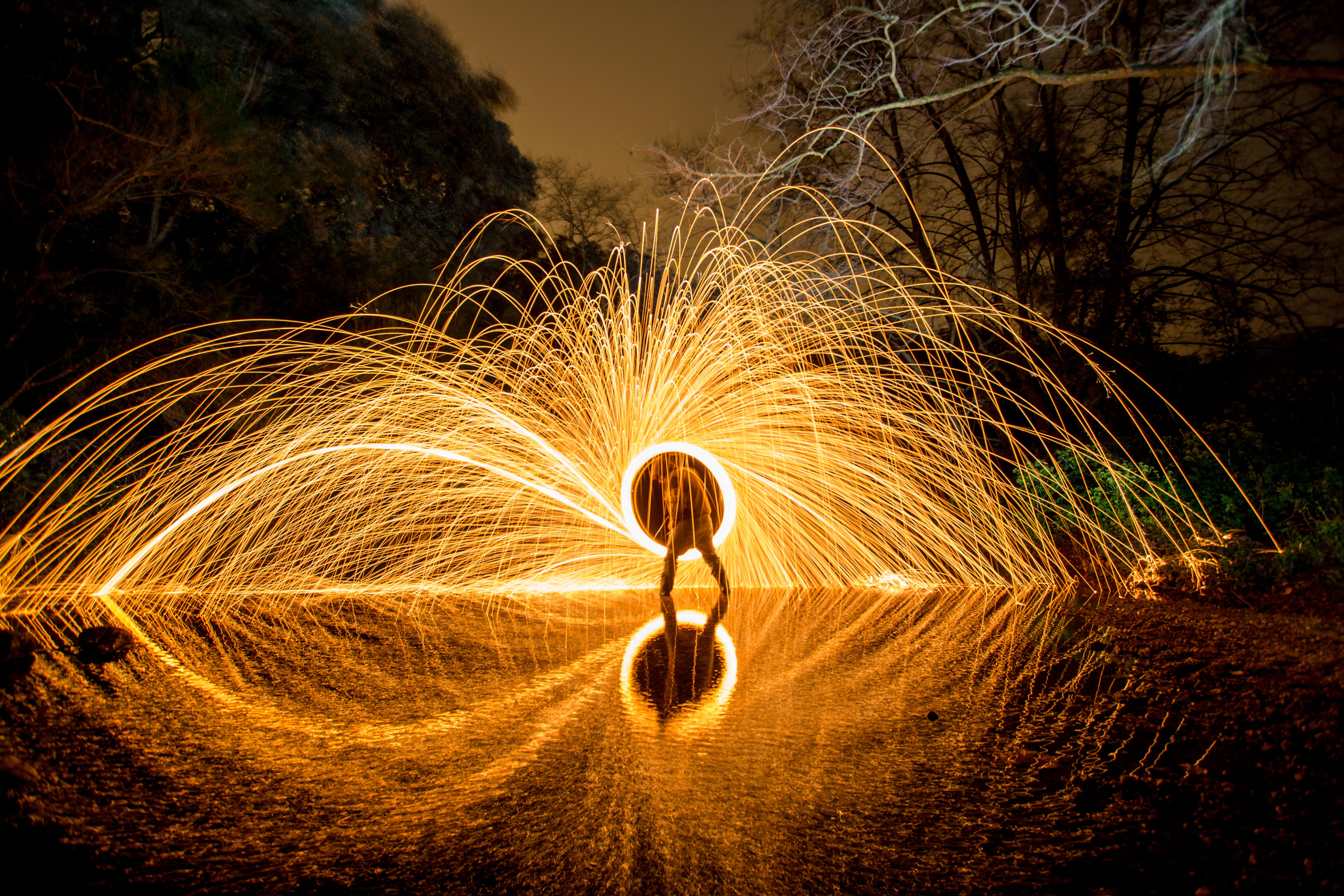 person-with-burning-circle-on-stones-between-wate